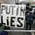 A protester in Moscow holds up a sign that reads 'Putin lies'
