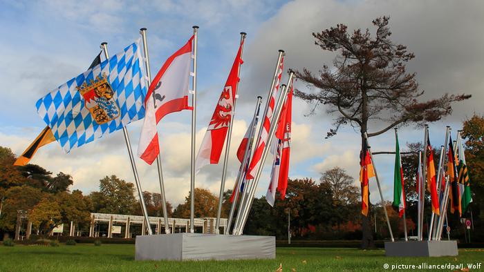 states' flags mounted outside a conference building