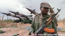(FILES) File picture of an Angolan soldier holding a Soviet-made AK-47 Kalachnikov submachine, as he guards a battery of Soviet-made ground-to-air missiles 29 February 1988 near Cuito Cuanavale, southern Angola, where Soviet-backed regular Angolan army and Cuban soldierswere fighting against anti-Marxist and Western-backed UNITA nationalist movement. Angola will celebrate on March 22, 2008, the 20th anniversary of the defeat at Cuito Canavale of the South African Defence Force that was fighting side-by-side with Jonas Savimbi UNITA rebels. The emphatic defeat of the apartheif force at Cuito Cuanavale opened the road to freedom for the people of Namibia and subsequently South Africa. AFP PHOTO PASCAL GUYOT/FILES (Photo credit should read PASCAL GUYOT/AFP/Getty Images).