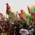 Supporters of the PAIGC party in Guinea-Bissau wave red, green and yellow flags as they celebrate the party's victory in the 2019 parliamentary election