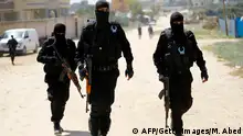 Hamas policemen carry out a raid in Nuseirat, south of Gaza City on March 22, 2018, that resulted in the arrest of a suspect in a recent bomb attack against the Palestinian prime minister, officials said.
Clashes erupted in Nuseirat in central Gaza as security forces from Hamas, the Islamist movement that runs the Gaza Strip, engaged in a manhunt for the suspect. / AFP PHOTO / MOHAMMED ABED (Photo credit should read MOHAMMED ABED/AFP/Getty Images)