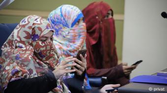 Women on smartphones in Pakistan