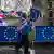 A person carrying Union Jacks and EU flags