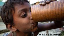 March 22, 2015 - Guwahati, Assam, India - An Indian boy drinks water from a municipal corporation water tank on World Water Day in Guwahati, capital of northeastern Assam state on March 22, 2015. A new UN report launched in New Delhi on March 20 ahead of World Water Day on March 22 warned of an urgent need to manage the world's water more sustainably and highlight the problem of groundwater over-extraction, particularly in India and China. Eighty percent of sewage in India is untreated and flows directly into the nation's rivers, polluting the main sources of drinking water, a study by an environment watchdog showed |