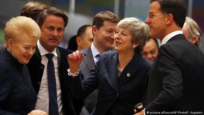 British Prime Minister Theresa May, center, speaks with Dutch Prime Minister Mark Rutte, right, and Lithuanian President Dalia Grybauskaite, left, during a round table meeting at an EU summit in Brussels, Thursday, March 21