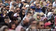 Members of the public look on during a gathering for congregational Friday prayers and two minutes of silence for victims of the twin mosque massacre, at Hagley Park in Christchurch on March 22, 2109. - The Muslim call to prayer rang out across New Zealand on March 22 followed by two minutes of silence nationwide to mark a week since a white supremacist gunned down 50 people at two mosques in the city of Christchurch. (Photo by WILLIAM WEST / AFP) (Photo credit should read WILLIAM WEST/AFP/Getty Images)