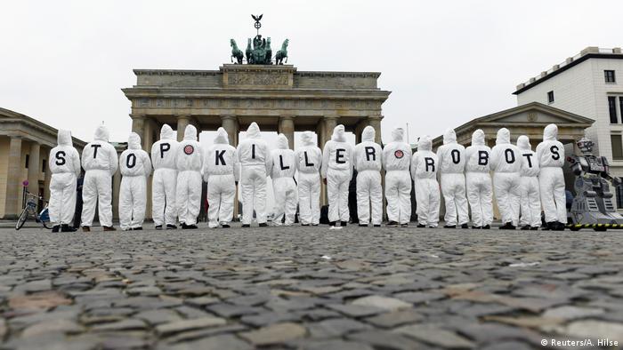 Activists from the Campaign to Stop Killer Robots protest in front of the Brandenburg Gate in Berlin