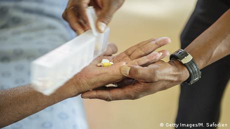 A patient receiving pills against tuberculosis