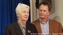 Edwin Hardeman (R) looks on as his wife Mary Hardeman (C) speaks during a press conferece after Edwin won his case against Monsanto in San Francisco, California on March 27, 2019. - Monsanto was ordered to pay some USD 81 million to an American retiree who blames his cancer on the agribusiness giant's weedkiller Roundup. A San Francisco jury found the firm had been negligent by not using reasonable care to warn of the risks of its product, ordering it to pay Edwin Hardeman USD 75 million in punitive damages, USD 5.6 million in compensation and USD 200,000 for medical expenses. (Photo by Julie CHARPENTRAT / AFP) (Photo credit should read JULIE CHARPENTRAT/AFP/Getty Images)