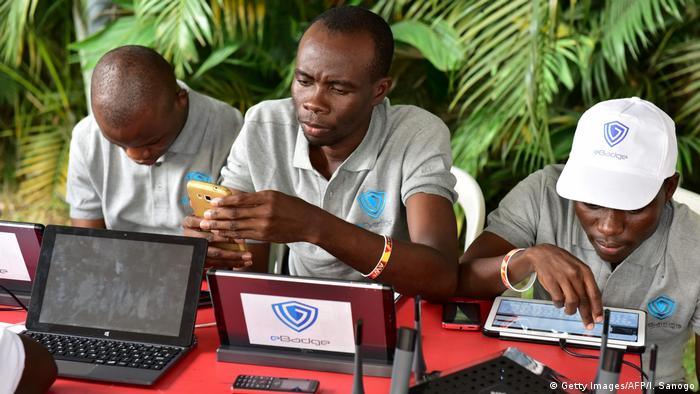 Visitors look at computers at the 2016 Africa Web Festival in Abidjan. Photo credit: Getty Images/AFP/I. Sanogo.