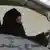 Саудовская правозащитница Азиза аль-Юсеф за рулем автомобиля в знак протеста против запрета для женщин на вождение машины (фото из архива)