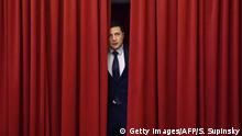 Ukrainian comic actor and the presidential candidate Volodymyr Zelensky enters a hall in Kiev on March 6, 2019, to take part in the shooting of the television series Servant of the People where he plays the role of the President of Ukraine. - Anger with the political elite is partly behind the rise of Volodymyr Zelensky, a TV actor with no political experience who is the frontrunner in the upcoming presidential vote. Zelensky is polling at 25 percent, ahead of Poroshenko on 17 percent and former prime minister Yulia Tymoshenko on 16 percent as of March 4, 2019. (Photo by Sergei SUPINSKY / AFP) (Photo credit should read SERGEI SUPINSKY/AFP/Getty Images)