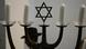 a menorah including four candles and centered by the Star of David a menorah including four candles and centered by the Star of David