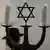 a menorah including four candles and centered by the Star of David
