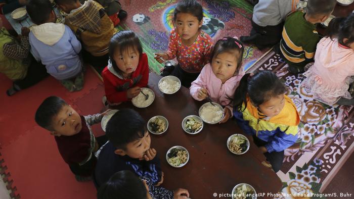 In this May 9, 2018 photo provided by the World Food Program (WFP), children eat a meal at a nursery and kindergarten where WFP provides food assistance in Sinwon county in North Korea's South Hwanghae province
