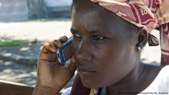 Woman on a telephone in Mozambique. Photo credit: picture-alliance/imagebroker/U. Doering.