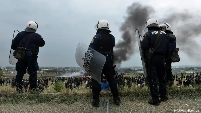 Greek police in front of a refugee camp outside Thessaloniki