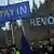 Remain protesters outside the Houses of Parliament in London, with placards saying "stay in" and "revoke"