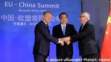Chinese Premier Li Keqiang, center, is welcomed by European Council President Donald Tusk, left, and European Commission President Jean-Claude Juncker ahead of an EU China Summit at the European Council building in Brussels, Tuesday, April 9, 2019. (Olivier Hoslet, Pool Photo via AP)