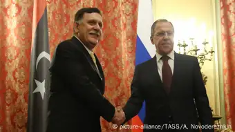 Libyas Prime Minister Fayez Sarraj (L) and Russia's Foreign Minister Sergei Lavrov shake hands at a meeting