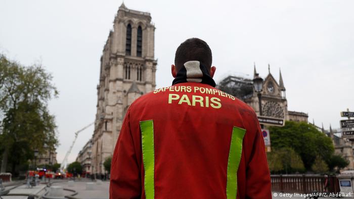 A firefighter in front of Notre Dame