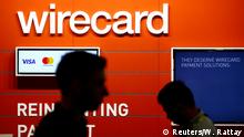 FILE PHOTO: People walk past the Wirecard booth at the computer games fair Gamescom in Cologne, Germany, August 22, 2018. REUTERS/Wolfgang Rattay/File Photo