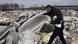 Alban Bernard lifts an old bathtub at an illegal dump near Carrieres-sous-Poissy Alban Bernard lifts an old bathtub at an illegal dump near Carrieres-sous-Poissy