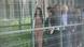 Ayse Celik walks with other individuals behind a fence Ayse Celik walks with other individuals behind a fence