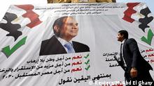 A man walks in front of a banner reading, Yes to the constitutional amendments, for a better future, with a photo of the Egyptian President Abdel Fattah al-Sisi before the approaching referendum on constitutional amendments in Cairo, Egypt April 16, 2019. REUTERS/Mohamed Abd El Ghany