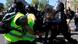 A protester scuffles with a police officer during a demonstration A protester scuffles with a police officer during a demonstration