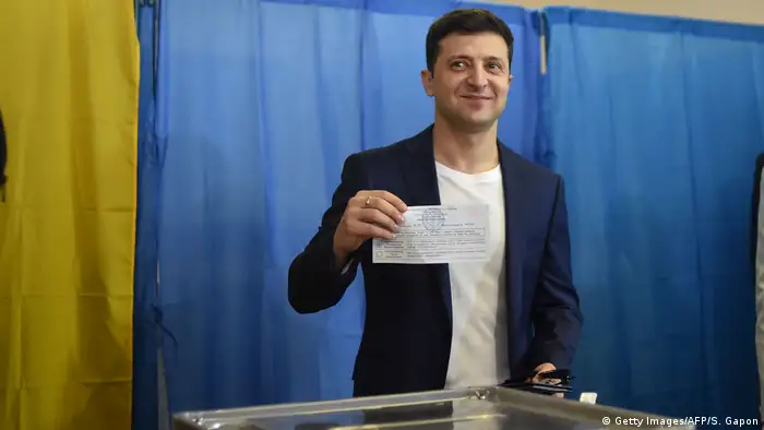 Владимир Зеленский на избирательном участке демонстрирует свой бюллетень для голосования