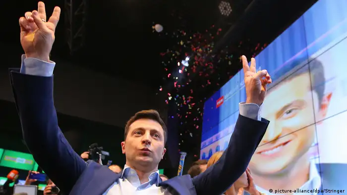 Ukrainian presidential candidate Volodymyr Zelensky reacts following the announcement of the first exit poll in a presidential election at his campaign headquarters in Kiev,