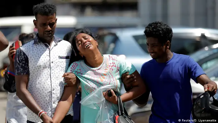 Relatives of victims react at a police mortuary following bomb blasts in Colombo