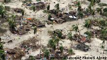 In this photo provided by the United Nations Office for the Coordination of Humanitarian Affairs (OCHA), badly damaged communities are seen from an aerial view, in Macomia district, Mozambique, on Saturday, April 27, 2019. Authorities have urged many residents to seek higher ground in the wake of Cyclone Kenneth as rain lashes the region. (Saviano Abreu/OCHA via AP) |