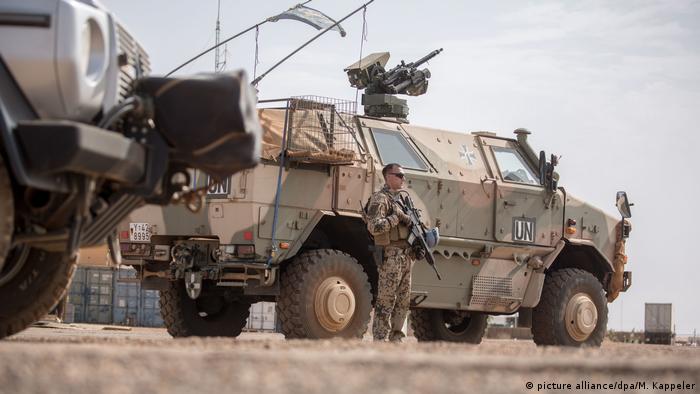 A German soldier stands next to a United Nations tank in Gao, Mali
