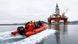 Greenpeace activists ride on an orange dingy boat to a Norwegian oil rig Greenpeace activists ride on an orange dingy boat to a Norwegian oil rig