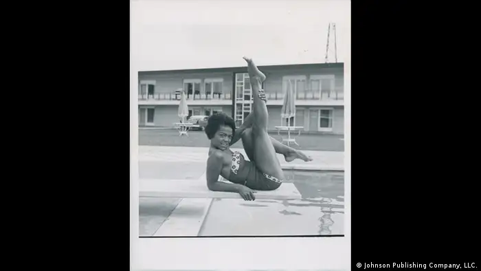 Afro-American model in bathing suit, lying on a diving board