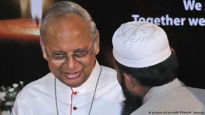 A Sri Lankan Muslim priest talks to Sri Lankan Archbishop Cardinal Malcolm Ranjith during a function to express solidarity with all the victims of Easter Sunday attacks, in Colombo, Sri Lanka, Sunday, April 28, 2019.