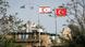 Greek and Cypriot Republic flags are visible across the separating green line from Turkish and Turkish Cypriot flags Greek and Cypriot Republic flags are visible across the separating green line from Turkish and Turkish Cypriot flags