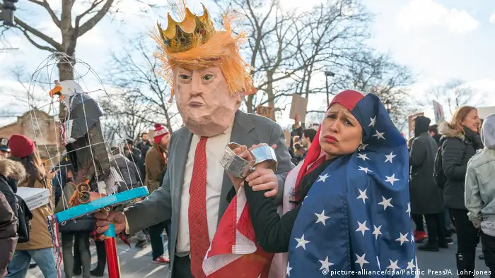 Man wearing Donald Trump head and woman with US flag hijab