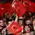 People waving Turkish flags