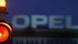 The Opel logo in the background, behind a red traffic light. The Opel logo in the background, behind a red traffic light.