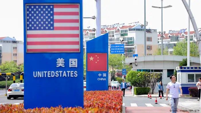 Signs with the US flag and Chinese flag at the Qingdao free trade port in China