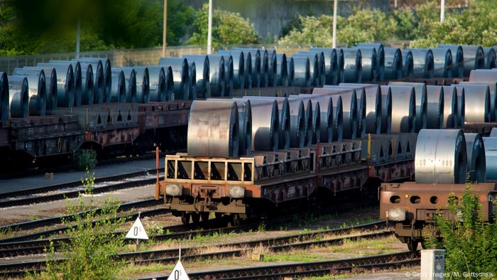 Rail cars loaded with rolled up steel 