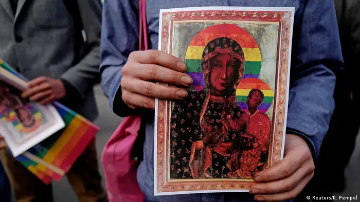 Person holding picture of 'rainbow madonna'