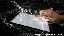 double exposure hand using tablet and city on night background PUBLICATIONxINxGERxSUIxAUTxONLY Copyright: xblackzheepx Panthermedia15763360