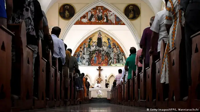 Sri Lankan Catholics pray during a Mass at St. Theresa's Church