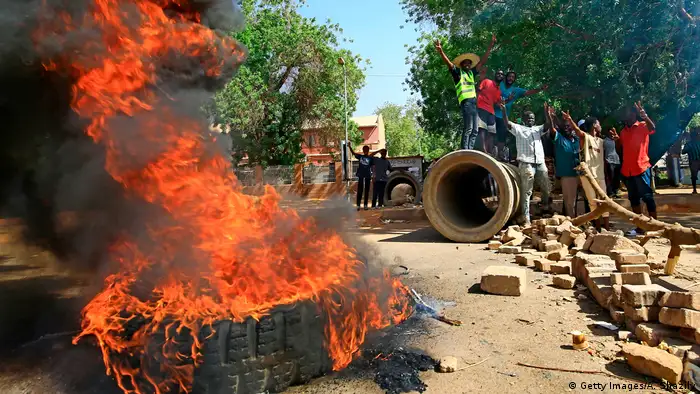 Sudanese protesters burn tires as they block Nile Street for the second consecutive day during continuing protests in Sudan's capital Khartoum