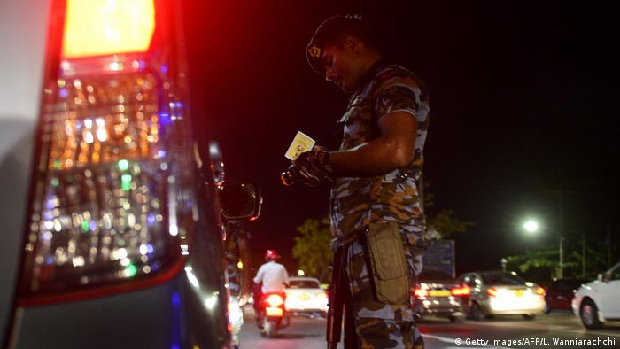 Sri Lanka security forces inspecting a car