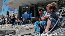 14.05.2019 *** Palestinian boys listen to members of the band Dawaween performing during a musical event calling for a boycott of the Eurovision Song Contest hosted by Israel, on the rubble of a building that was recently destroyed by Israeli air strikes, in Gaza City on May 14, 2019. (Photo by MAHMUD HAMS / AFP) (Photo credit should read MAHMUD HAMS/AFP/Getty Images)